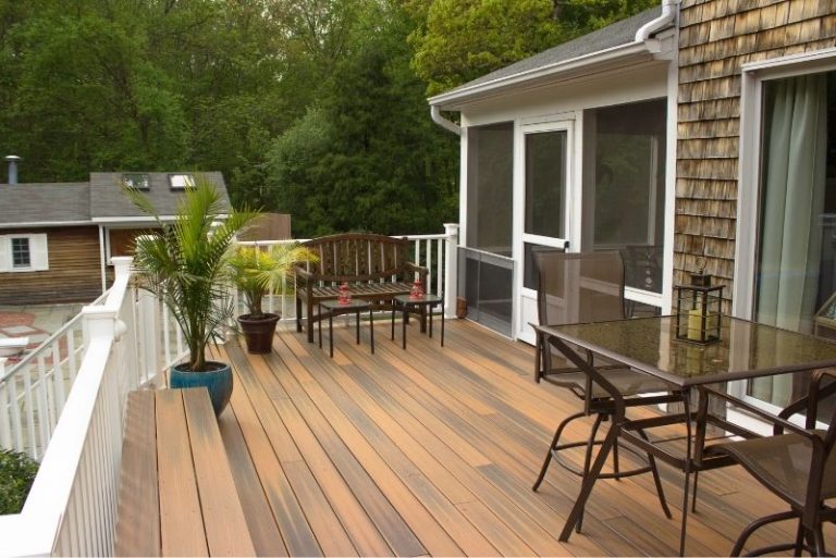 Elevated timber deck with outdoor seating attached to a house with a screened porch