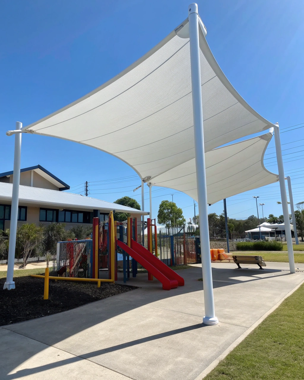 Large commercial shade sail structure covering a school outdoor area